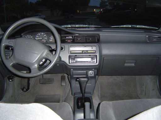 Cockpit of the car: JVC CD Player, Honda Sticker, Custom floor mats